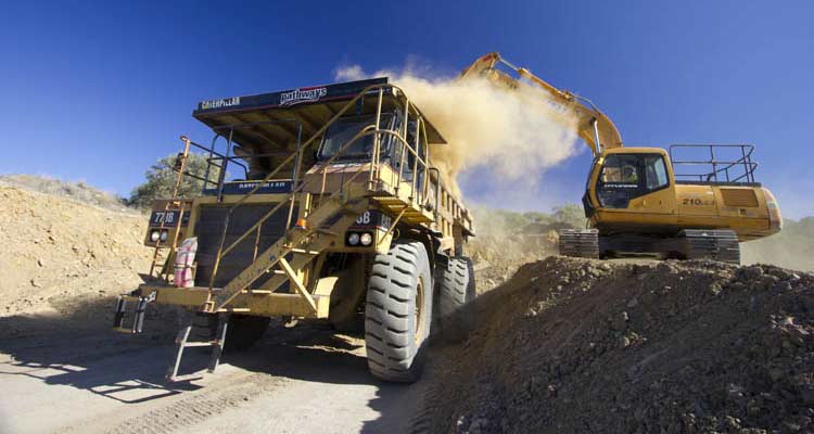 mining dump truck loaded CAT 773 Hitachi excavator